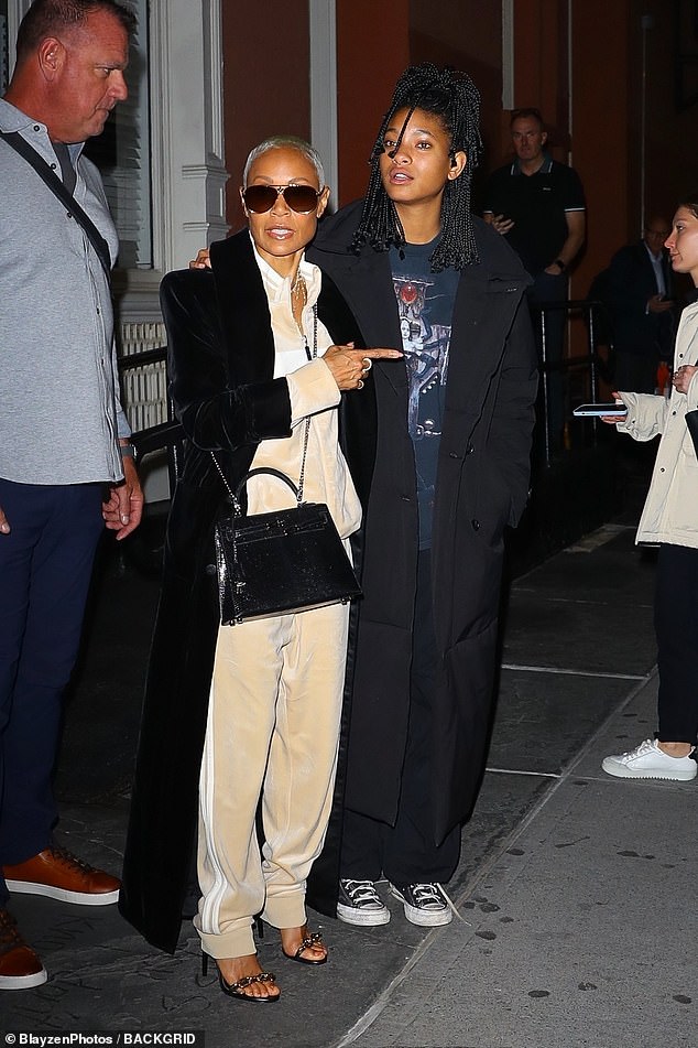 Cozy: Jada completed the outfit with black open-toe heels.  The entertainer wore dark aviator glasses and a black bag for a night out