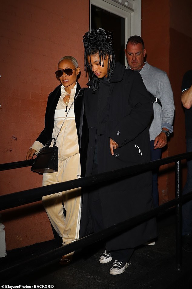 Dynamic duo: Like her mother, Willow also wore a long black coat.  Underneath, she wore a navy blue T-shirt, black pants and classic Converse sneakers