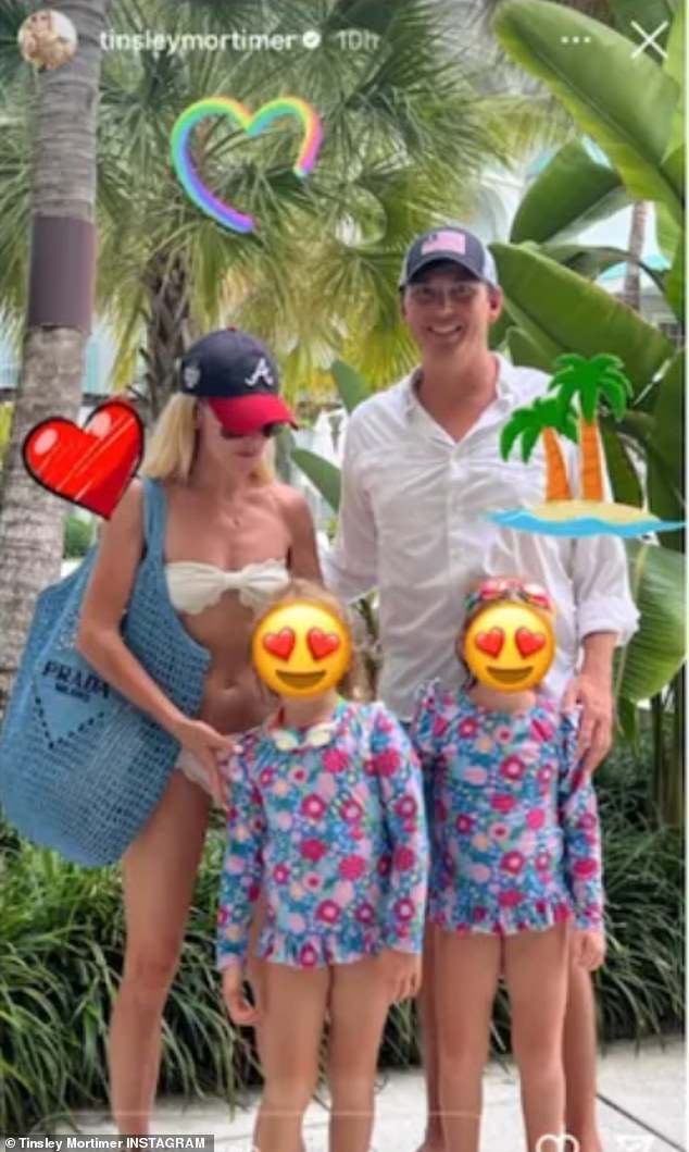 Blended family: Another snap from her tropical getaway with Bovard and his three children showed the Columbia University graduate carrying a $2,050 blue Prada bag over her shoulder as she stood behind her husband-to-be's two youngest children