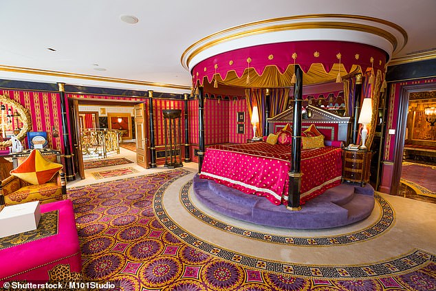 The ornate bedroom, complete with a royal four-poster bed, takes up half of the suite's top floor