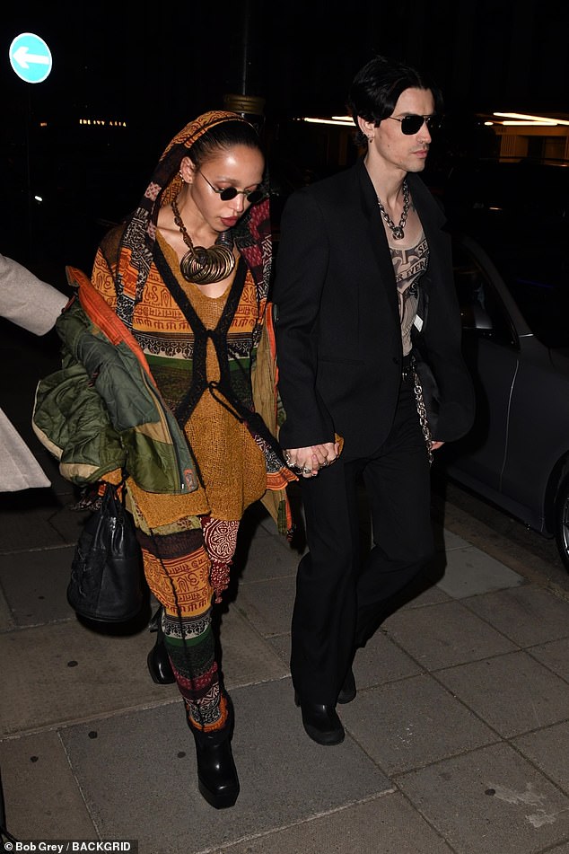 Looking good: She turned heads in a mustard yellow patterned top, teamed with a matching scarf and trousers