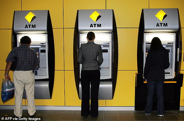 718 ATMs have been removed in the past year alone, with less than one in five in-store transactions now made in cash (pictured are Commonwealth Bank ATMs in Sydney)