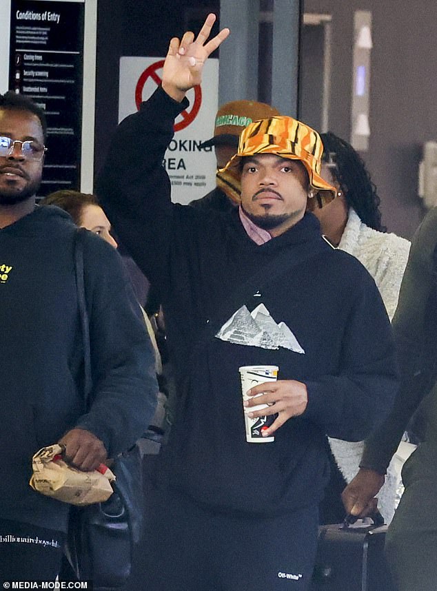 The rapper wore pants, a sweater with a print of the Pyramids of Giza, and sneakers