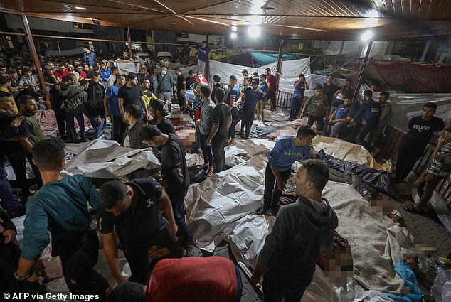 On Tuesday, bodies of victims of the strike at al-Ahli hospital are seen lined up in a courtyard