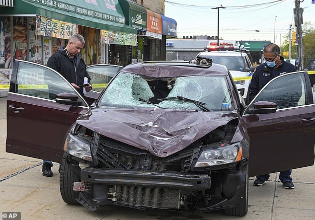 Investigators examine the vehicle that struck and killed New York Police Department officer Anastasios Tsakos