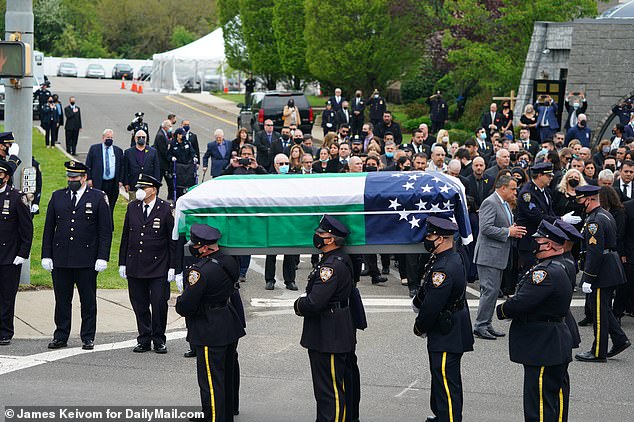 Police officers carry Tsakos' coffin.  His work and private motorcycles were also put into service for the enthusiastic motorcyclist