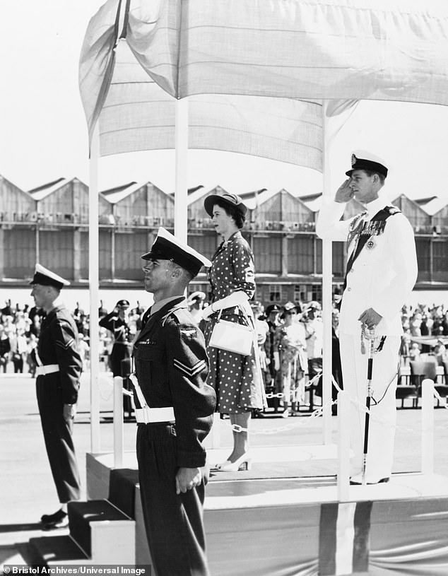 Princess Elizabeth and the Duke of Edinburgh stand at attention upon their arrival at Eastleigh Airport in Nairobi, 1952