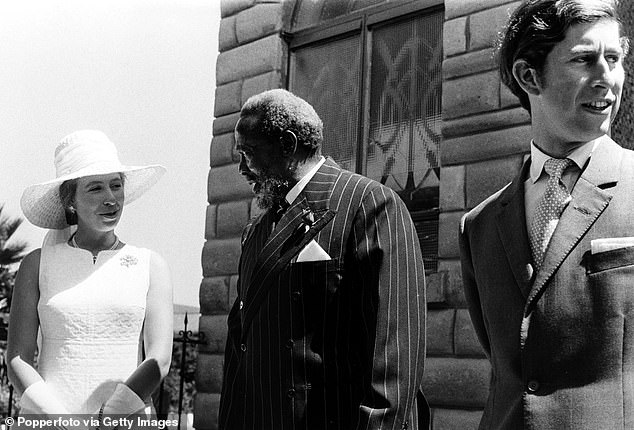 Princess Anne talks to President Jomo Kenyatta while Prince Charles looks around