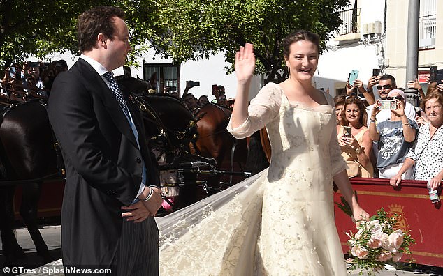 The aristocrat waved to her well-wishers as she entered the church in Jerez de la Frontera in Spain's Andalusia region