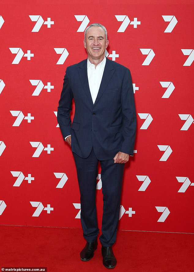 The veteran broadcaster was all smiles as he posed up a storm on the red carpet in an impeccably tailored navy suit