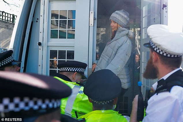 Other protesters were told to stand back as Ms Thunberg smiled from the back of the police van