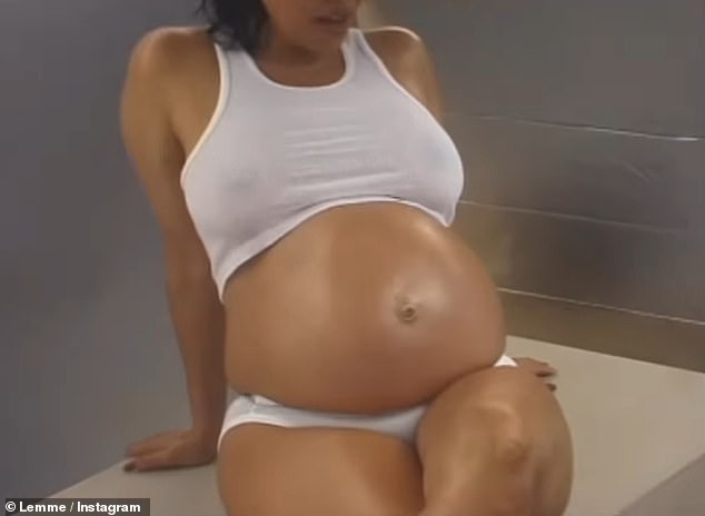 Pregnant: She looked amazing as she lounged around in a white crop top and underwear which showed off her blossoming baby bump as she posed for the cameras