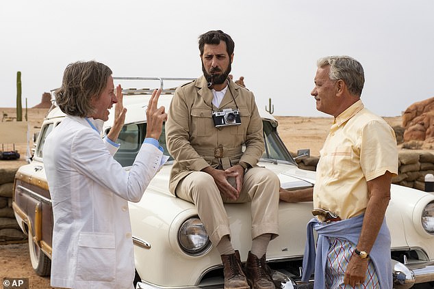 Set: The Oscar-winning director has revealed that employees staged a 'mutiny' after he placed folding tables on the side of the set so they could quickly get back to work (photo of Wes with Jason Schwartzman, center, and Tom Hanks on the set of Asteroid City)