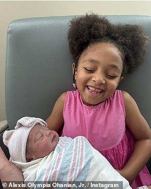 Olympia holds Adira shortly after she was born in August this year