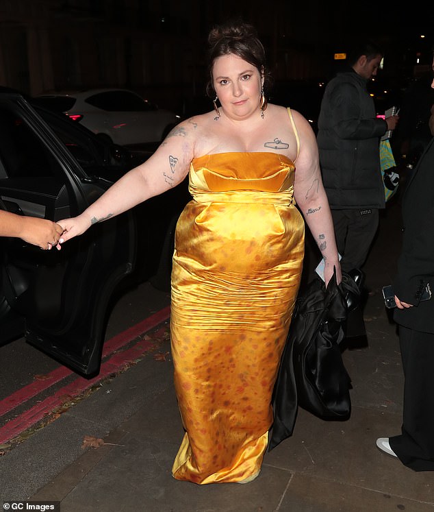 Stepping out: The brunette beauty donned yellow stockings to match her gorgeous satin yellow dress