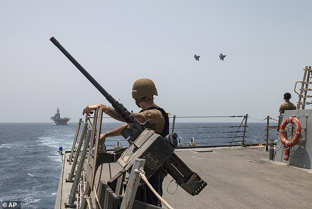 Two U.S. Air Force F-35A Lightning II fighter jets fly alongside the USS Bataan amphibious assault ship in the Gulf of Oman amid rising tensions with Iran