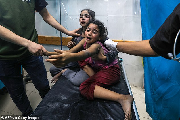 Children injured during the hospital strike cry Tuesday as they receive treatment at Nasser Hospital in Khan Yunis in southern Gaza Strip