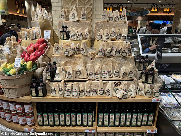 Blocks of parmesan cheese and olive oil lined the shelves of the new Wegmans on Astor Place.