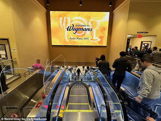 Pictured is the escalator at the back of the store that takes shoppers to the lower level