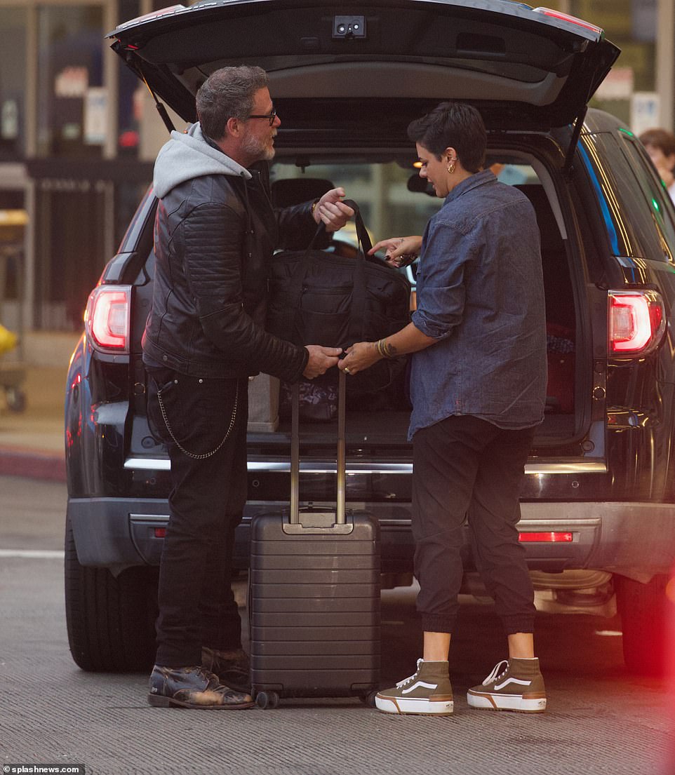 A helping hand!  Dean, dressed in a smart leather jacket and jeans with chain detailing, was seen obligingly unloading Lily's belongings from the back of his truck