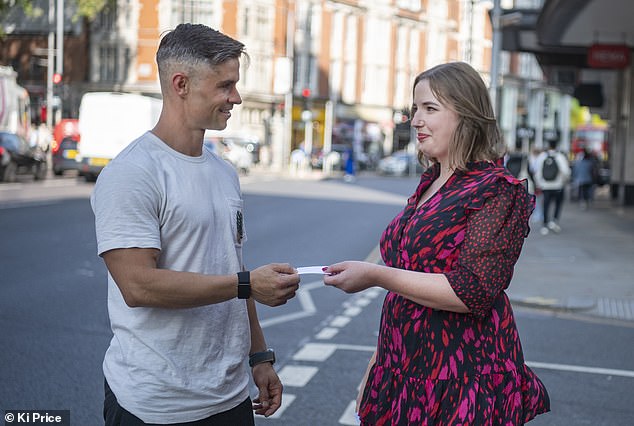 Sophie hands out one of her dating cards to Lucas Salge in London.  She also handed them out on public transport and in her hometown of Leeds