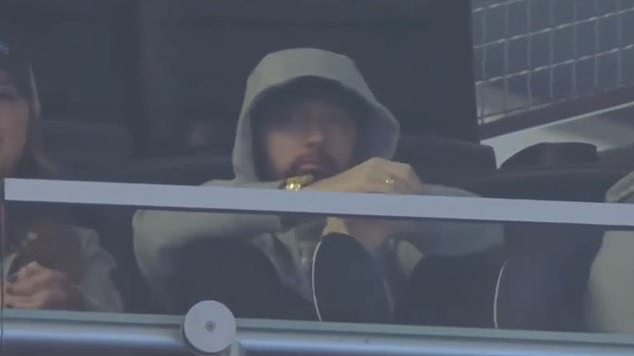 Family support: Eminem can be seen at the Lions' win over the Buccaneers with his daughter, Haley Jade Scott, sitting to his right