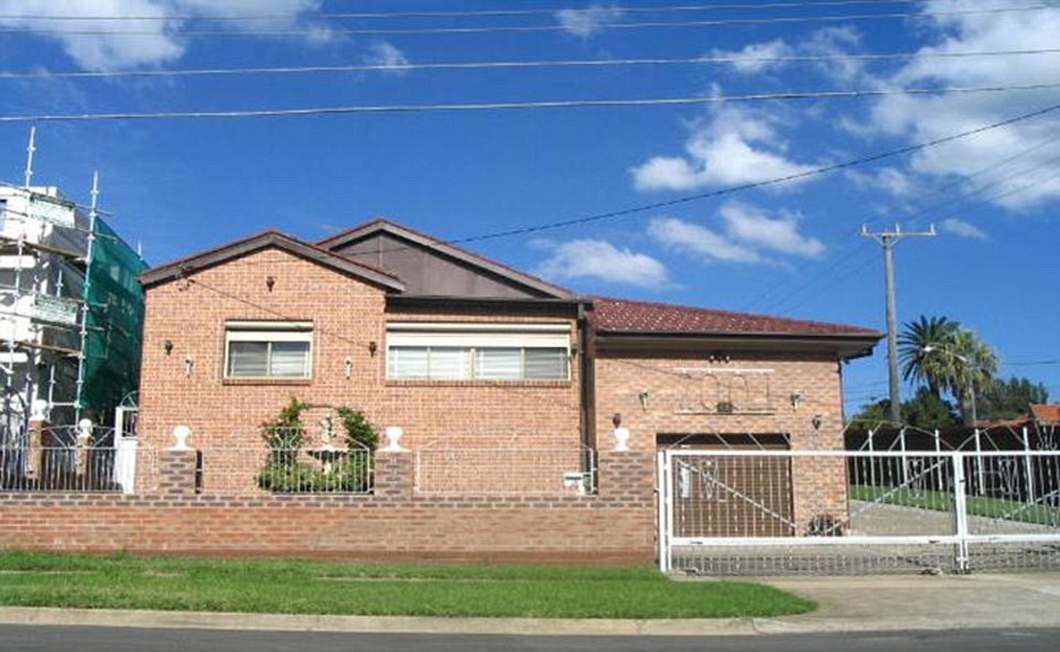 The 2005 house before the massive security upgrade has shutters and a gate, but nothing else