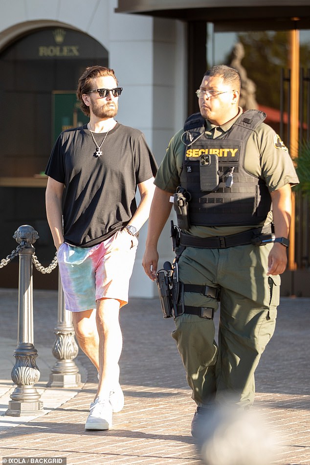 Follow the leader: His security staff kept an eye on him as he led the way to the E!  alum