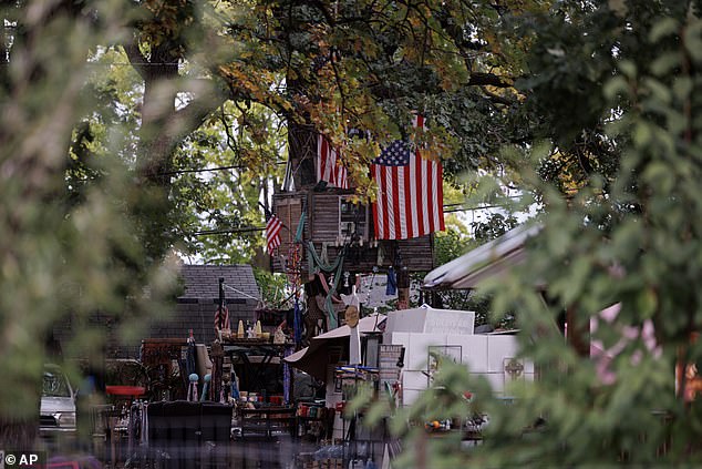 The backyard of the house where Czuba stabbed the boy and his mother.  It is full of American flags and other patriotic signs