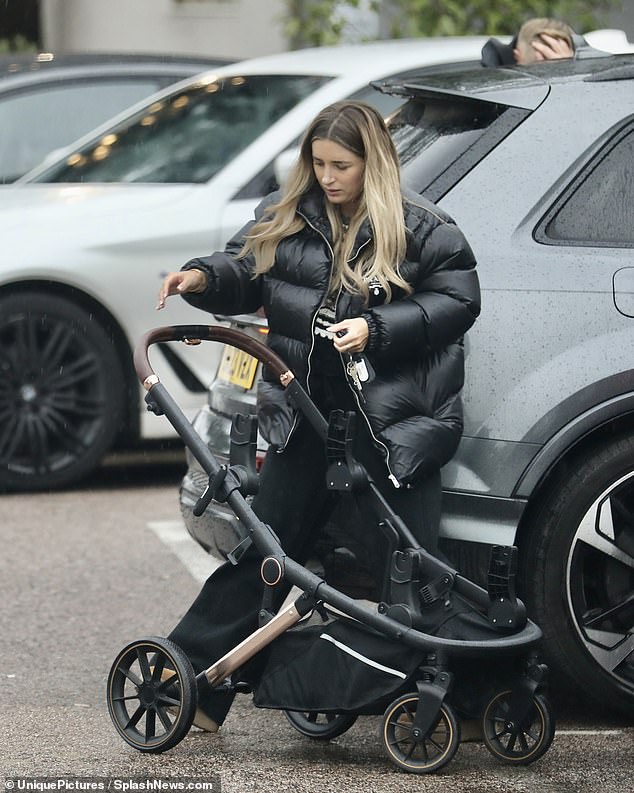 Outside: Danny put the pram back in the car as Jarrod strapped the twins into their car seats