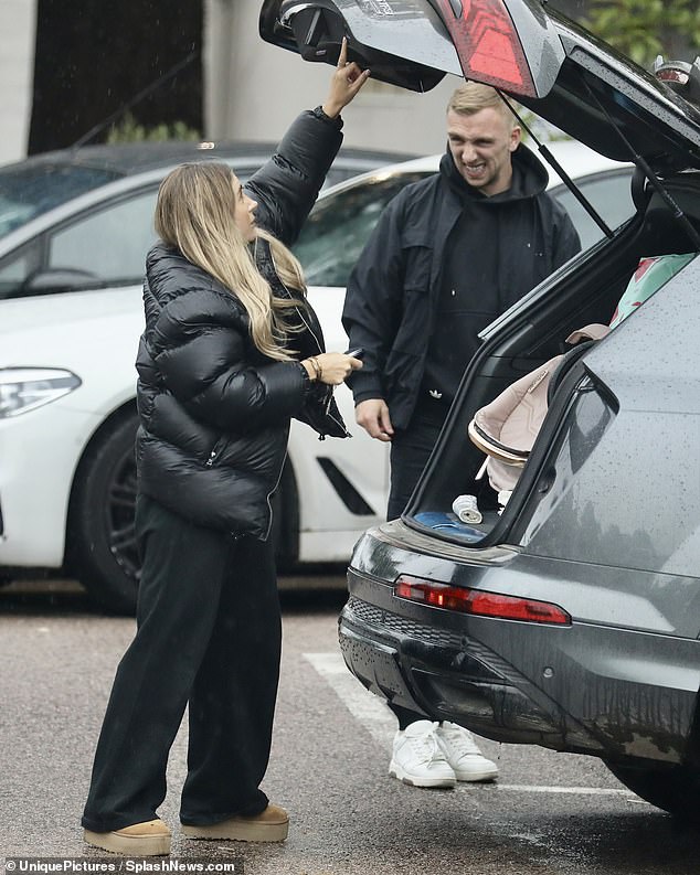 All packed up: Dani and Jarrod braved the rain as they headed out for their morning walk first