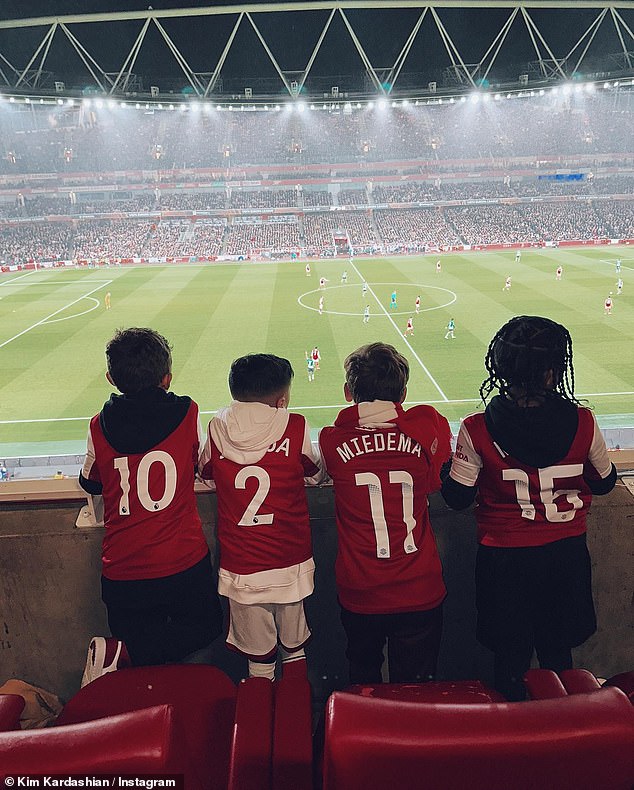 The children pose in Arsenal shirts, with the names of defender William Saliba and Arsenal Women star Viv Miedema