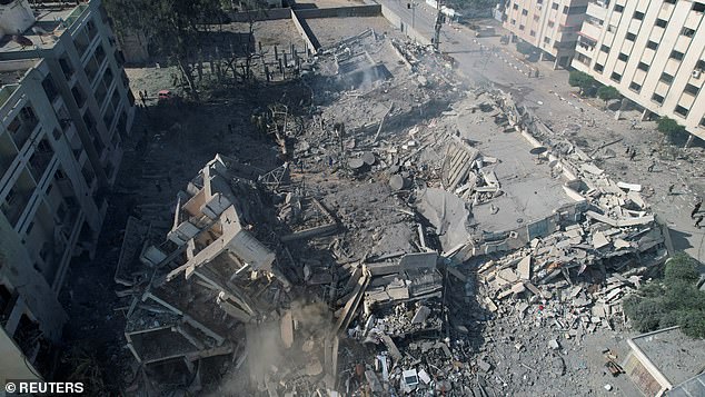 Palestinians gather Thursday around residential buildings destroyed in Israeli attacks in Zahra City