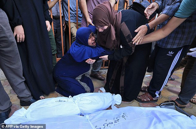 Relatives of Palestinians killed in an Israeli airstrike mourn their bodies Thursday at a hospital in Khan Yunis in the southern Gaza Strip