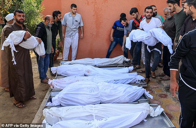 People carry the bodies of Palestinians killed in an Israeli airstrike outside a hospital in Khan Yunis in the southern Gaza Strip on Thursday