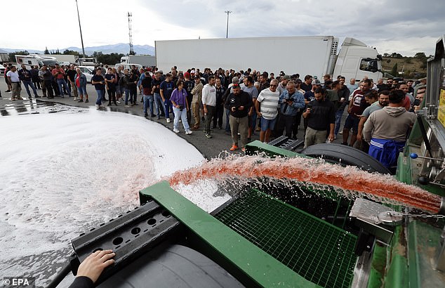 After I opened the lip of a truck, gallons of red wine poured onto the road