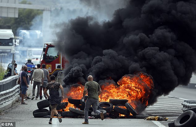 The enraged winemakers also piled up several crates of tomatoes and tires before setting them on fire (pictured here)