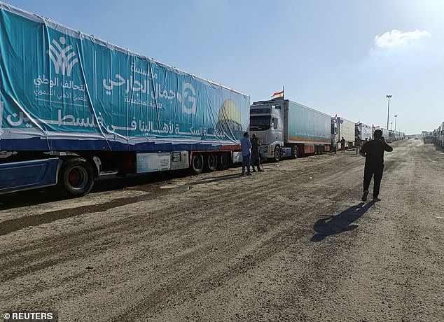 Trucks carrying humanitarian aid from Egyptian charities for Palestinians await the reopening of the Rafah crossing on the Egyptian side of the border