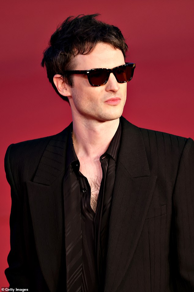 Mysterious: Tom completed the look with some dark shades which he wore during the red carpet event