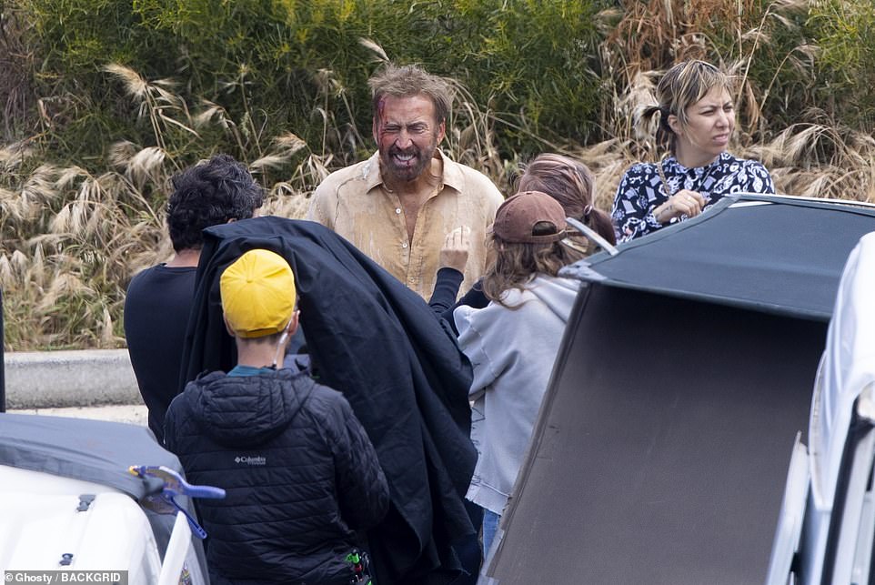 Crew came to his rescue to adjust his outfit and complement his bloodied face with costume and movie makeup