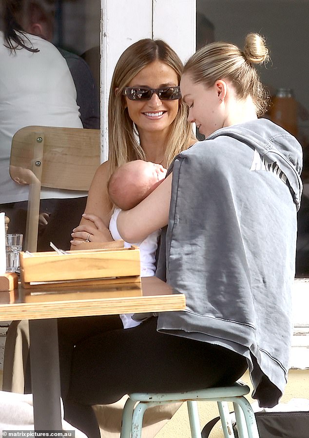 The new parents were all smiles as they met their pals for breakfast, bringing baby Robbie along for them to rock and admire