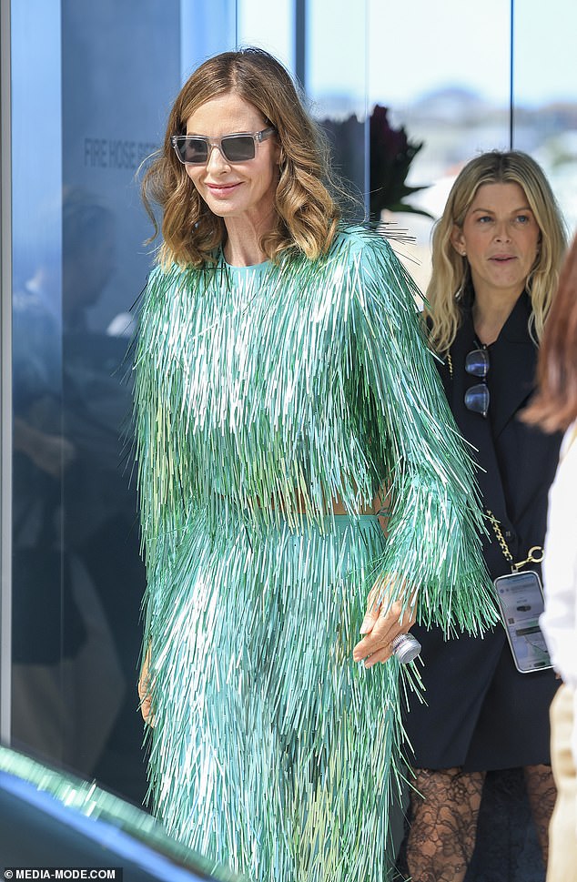 Woman of the Hour Trinny dazzled for lunch in a turquoise long sleeve top and matching streamer style skirt