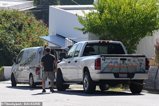 Locksmiths are pictured at the Brentwood home where the woman dubbed 'America's worst Airbnb renter' lives