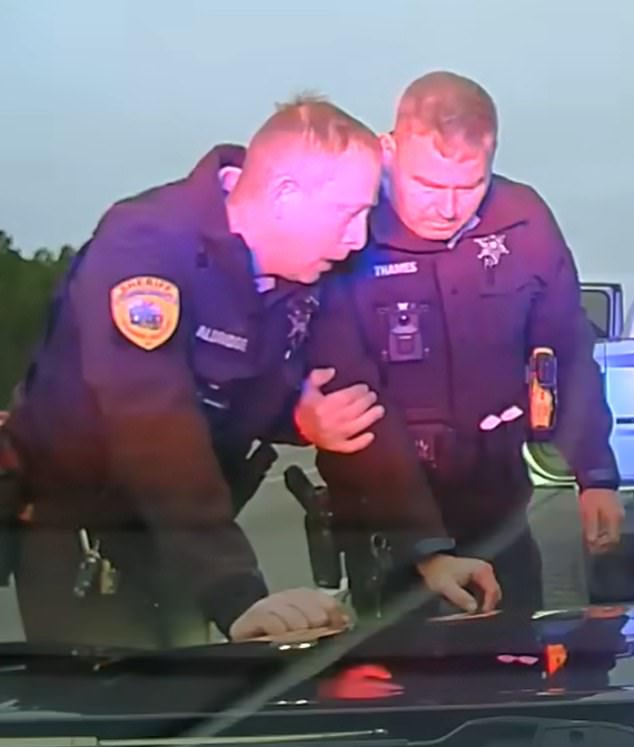 Aldridge, pictured left comforted after the shooting, received several previous warnings about his behavior, especially during traffic stops