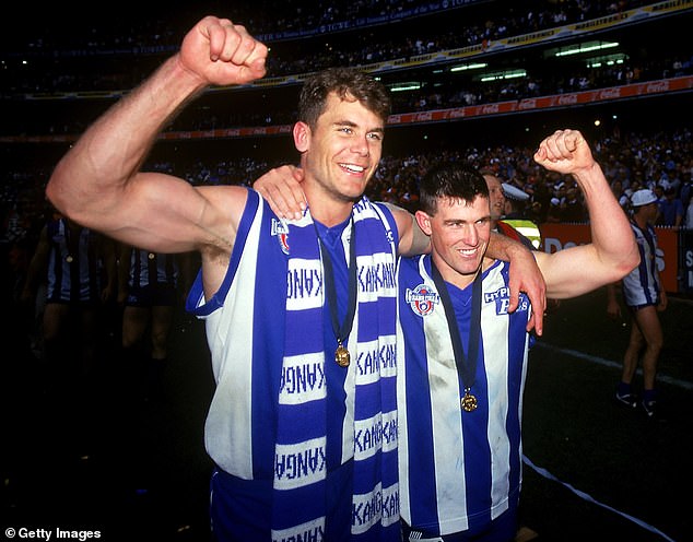 Carey and Stevens of the Kangaroos celebrate victory after the 1996 AFL Grand Final match between the North Melbourne Kangaroos and the Sydney Swans