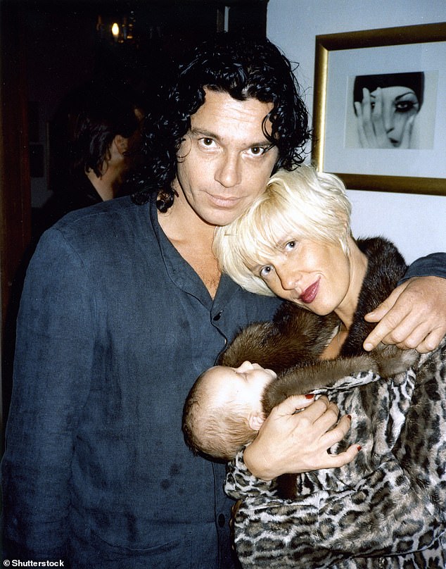 The happy couple: His partner Paula Yates claimed a year before her own death that he probably died accidentally while choking himself for sexual pleasure, as the pair had engaged in similar sex games (the couple pictured with their daughter Tiger Lily in 1996)