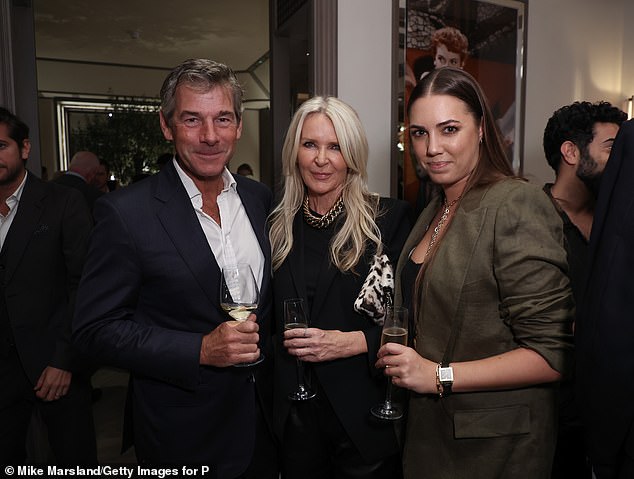 Looking good: She wore her long tresses down as she was snapped posing next to Amanda Wakeley