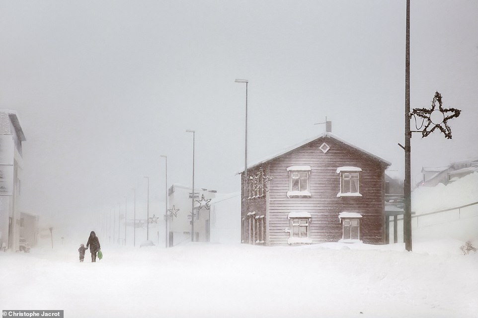 This striking shot was taken in Greenland.  About photographing cold countries around the world, Jacrot says: 'I discovered a blindingly white, cold, hostile nature.  A frozen and chilling world... but not quite!  No matter how small, there is always a spark of life.  A touch of color, fleeting silhouettes, birds in flight, something poetic that thaws in the beauty of this extreme climate'