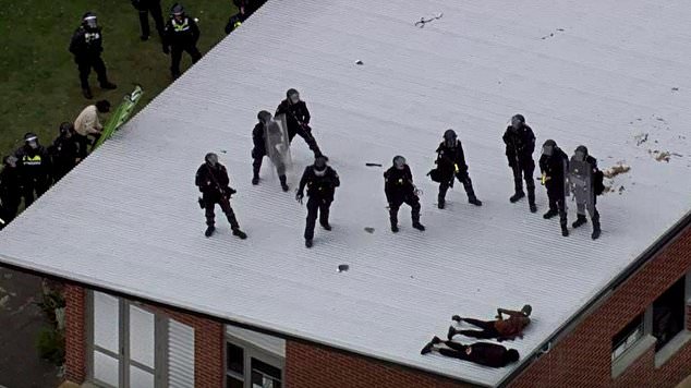 Riot police subdue prisoners during a riot on Banksia Hill