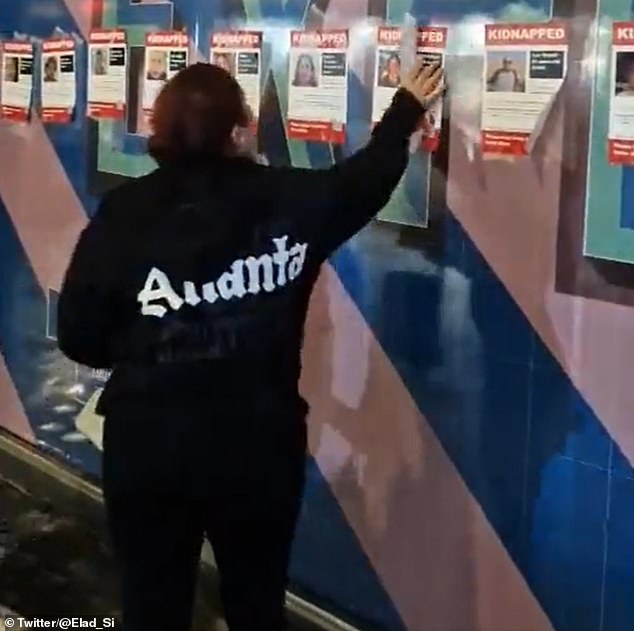 Another woman was tearing down posters in support of Israel